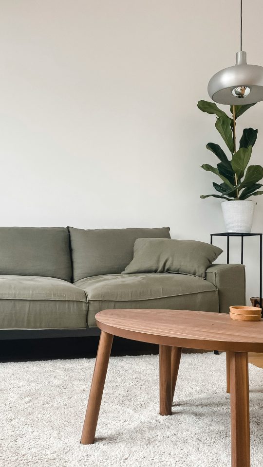 gray 2 seat sofa near brown wooden coffee table